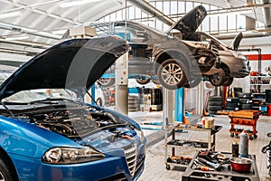 Modern automobile repair workshop with lifted cars