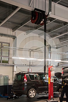 Modern automobile service station with fumes exhaust vetillation unit and elevators