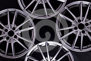 Modern automotive alloy wheel made of aluminum on a black background, industry. Designer fashion wheels for car
