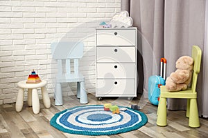 Modern baby room interior with white chest