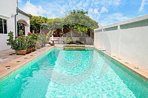 Modern backyard of a swimming pool with house