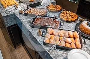 Modern bakery with assortment of bread, cakes and buns at a hotel.