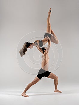 Modern ballet dancer couple in black form performing art jump with empty copy space background, izolated