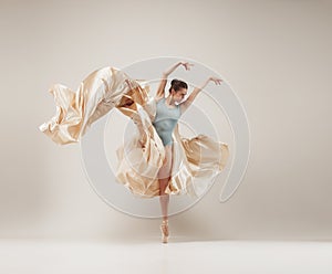 Modern ballet dancer dancing in full body on white studio background.