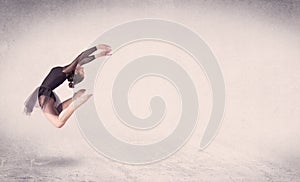 Modern ballet dancer performing art jump with empty background