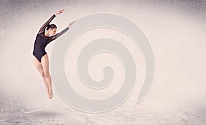 Modern ballet dancer performing art jump with empty background