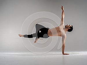 Modern ballet dancer performing art jump with empty copy space background, izolated