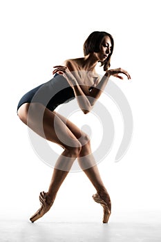 Modern ballet dancer posing on white background