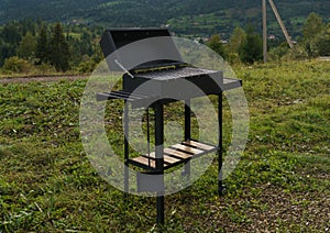 Modern barbeque grill outdoor with mountain view with copy space