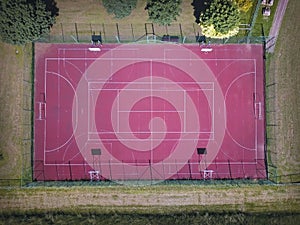 Modern basketball court in the courtyard on the centre of municipal sports and recreation. View of bird`s fly or drone. Modern bas