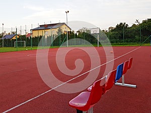 Modern basketball court in the courtyard of primary school. Multifunctional children`s playground with artificial surfaced fenced