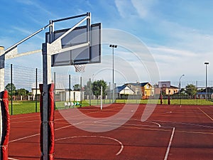 Modern basketball court in the courtyard of primary school. Multifunctional children`s playground with artificial surfaced fenced