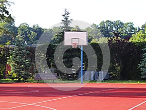 Modern basketball court in the courtyard of primary school. Multifunctional children`s playground with artificial surfaced fenced