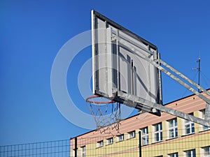 Modern basketball court in the courtyard of primary school. Multifunctional children`s playground with artificial surfaced fenced