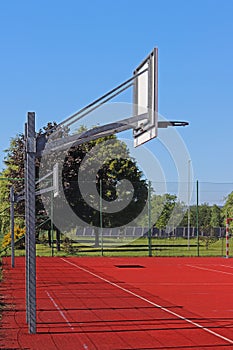 Modern basketball court in the courtyard of primary school. Multifunctional children`s playground with artificial surfaced fenced