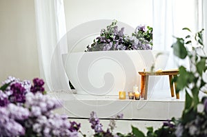 Modern bath room and spa center on the white tub wooden table