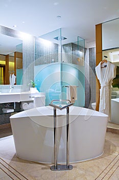 The fashion modern bathroom, including bathtub, shower, basins and toilet photo
