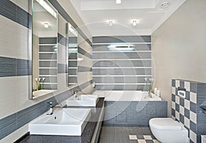 Modern bathroom in blue and gray tones with mosaic