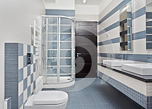 Modern bathroom in blue with shower cubicle