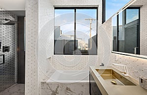 Modern bathroom with contemporary sinks, mirrors, and window