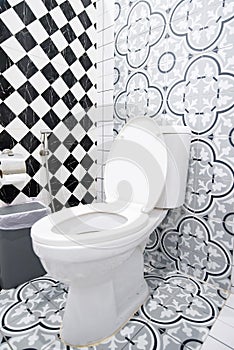 Modern bathroom design featuring artistic wall patterns and checkerboard tiles.