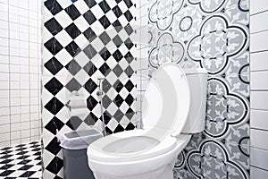 Modern bathroom design featuring artistic wall patterns and checkerboard tiles.