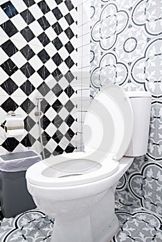 Modern bathroom design featuring artistic wall patterns and checkerboard tiles.