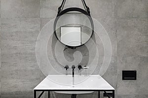 Modern bathroom detail with black taps