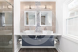 A modern bathroom with a floating blue vanity cabinet.