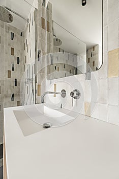 Modern bathroom with frameless mirror, one-piece white porcelain