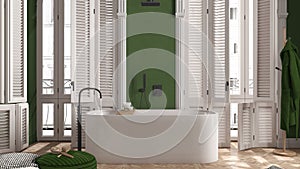 Modern bathroom in green tones in classic apartment with window with shutters and parquet. Freestanding bathtub, pouf with