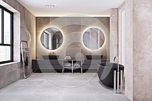 Modern bathroom interior with bath tub, illuminated round mirrors and black washbasins.