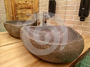 Modern bathroom interior design. Stone sink on wooden deck.