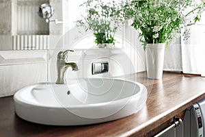 Modern bathroom interior with stylish mirror and vessel sink