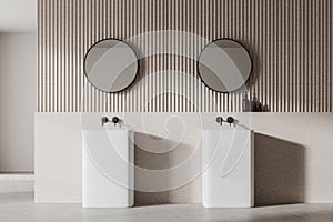 Modern bathroom interior with two sinks, round mirrors