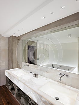 Modern bathroom with marble and parquet, nobody