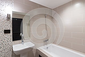 Modern bathroom with a shower and bathtub.