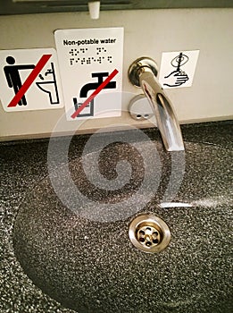 Modern bathroom sink and faucet in public toilet and restroom. Touchless taps. Virus protection concept. Sanitary rules
