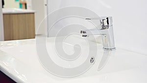 Modern bathroom sink, water tap and chrome faucet for bath basin