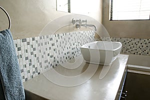 Modern bathroom sink with white mosaics