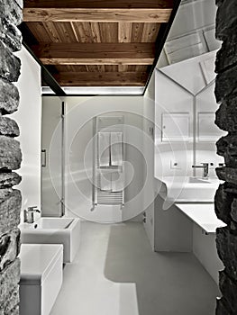 modern bathroom with stone walls and resin floor