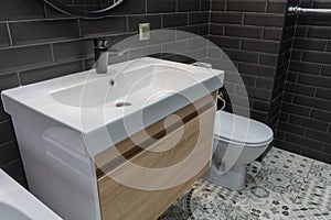Modern bathroom suite with wall mounted wc and sink unit and large mirror