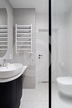 Modern bathroom with terrazzo tiles and reinforced glass