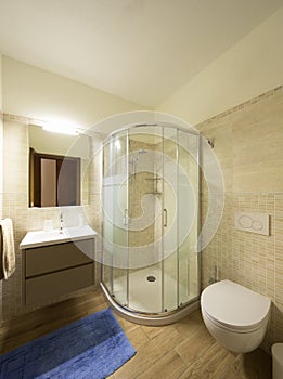 Modern bathroom with tiles. Large shower.