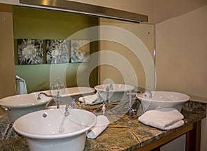 Modern bathroom with two elegant retro white ceramic wash basins