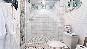 Modern bathroom with a white tile floor and white fixtures