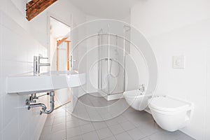 Modern bathroom - white tiled bath with shower