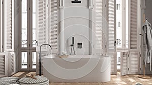 Modern bathroom in white tones in classic apartment with window with shutters and parquet. Freestanding bathtub, pouf with