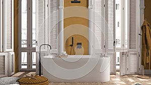 Modern bathroom in yellow tones in classic apartment with window with shutters and parquet. Freestanding bathtub, pouf with