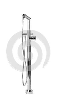 Modern bathtub faucet with hand shower on grey background